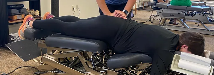 Chiropractor Iowa City IA Christine Bowman Adjusting Pregnant Patient